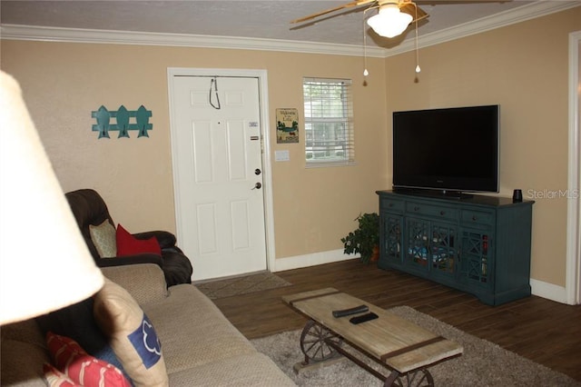 living room featuring dark hardwood / wood-style floors, ceiling fan, and crown molding