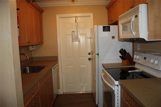 kitchen featuring dark hardwood / wood-style flooring, white appliances, ornamental molding, and sink