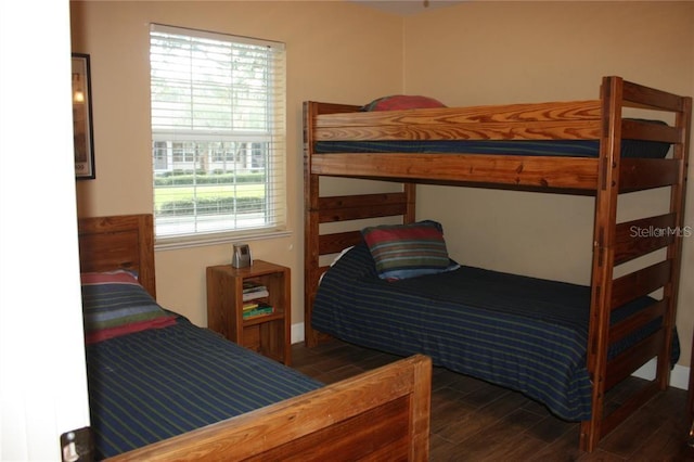 bedroom with dark wood-type flooring