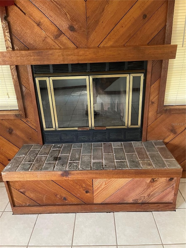 room details with wood walls and a fireplace