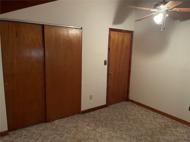 unfurnished bedroom featuring light carpet, a closet, and ceiling fan