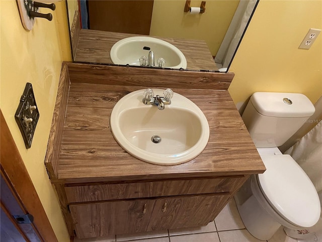 bathroom with tile patterned floors, vanity, and toilet