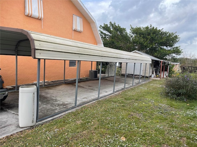 view of parking / parking lot with a carport and a lawn