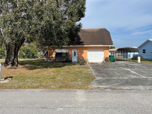 view of front of property with a front lawn and a carport