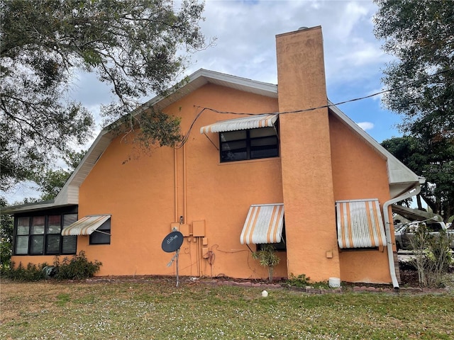 view of side of home featuring a yard