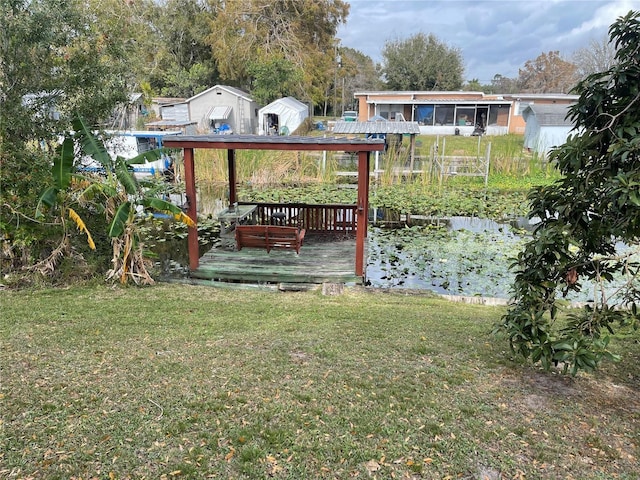 view of yard featuring a deck and a storage shed