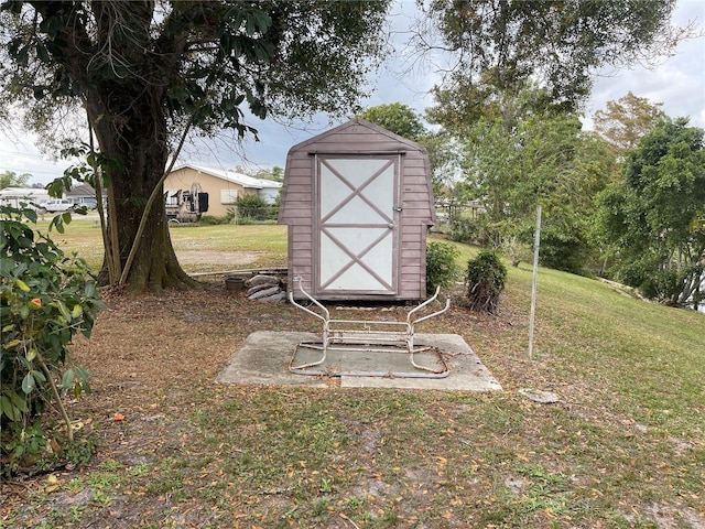 view of outbuilding featuring a yard