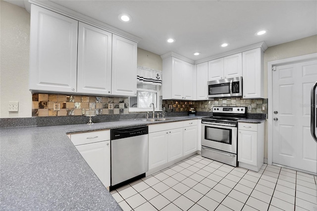 kitchen with white cabinets, light tile patterned flooring, sink, and stainless steel appliances