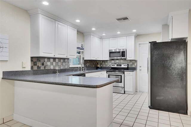 kitchen featuring kitchen peninsula, stainless steel appliances, white cabinetry, and light tile patterned flooring