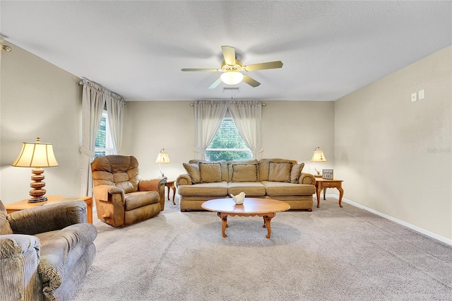 carpeted living room featuring ceiling fan, a healthy amount of sunlight, and a textured ceiling