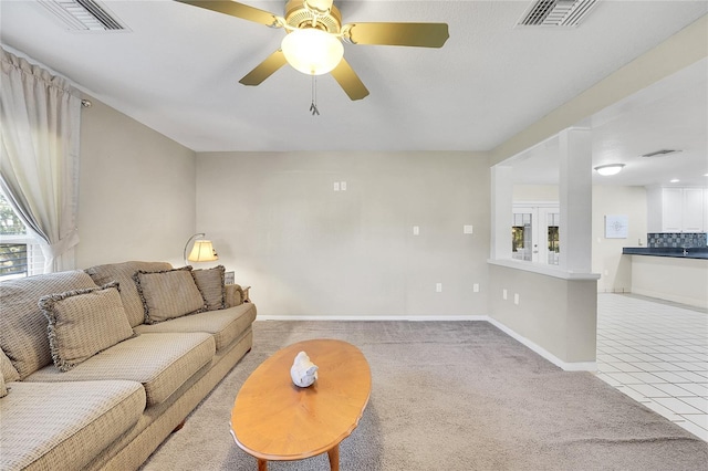 tiled living room featuring ceiling fan