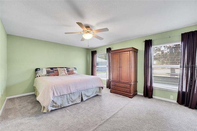 carpeted bedroom featuring a textured ceiling and ceiling fan