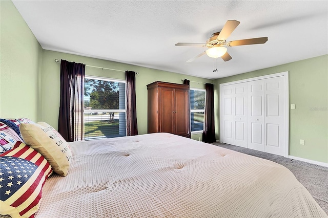 bedroom with carpet flooring, a textured ceiling, a closet, and ceiling fan