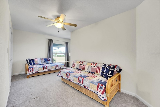 carpeted bedroom with a textured ceiling and ceiling fan