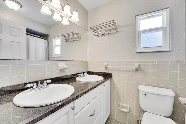 bathroom featuring vanity, a shower with shower curtain, tile walls, and toilet