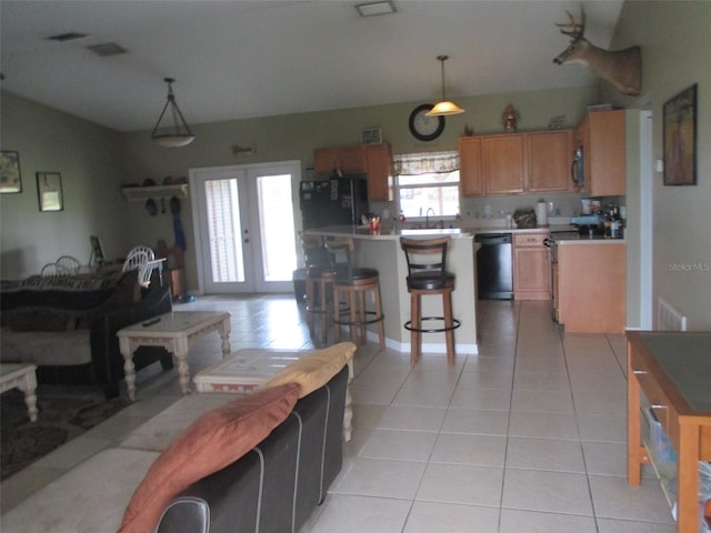 kitchen with range with electric cooktop, dishwasher, pendant lighting, black refrigerator, and light tile patterned floors