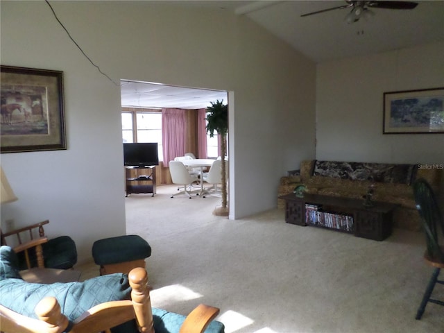 living area with lofted ceiling with beams, carpet flooring, and ceiling fan