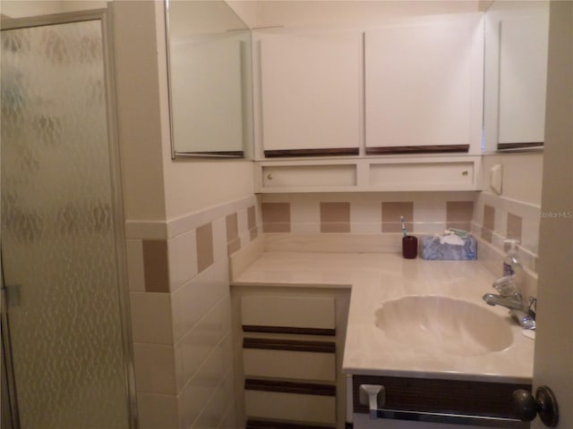 full bath featuring a stall shower and vanity