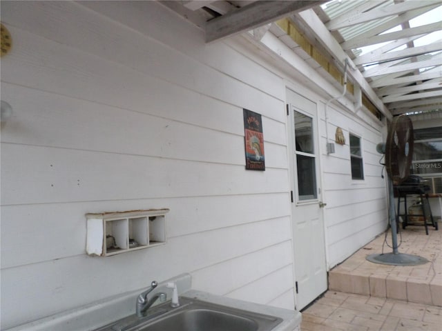 exterior space featuring a jacuzzi and a sink