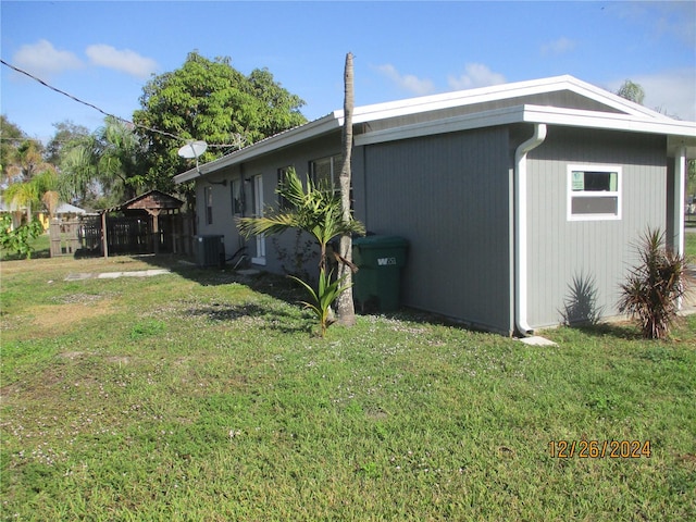 view of home's exterior with a lawn and central air condition unit