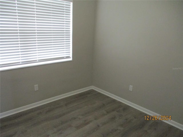 empty room with dark wood-type flooring