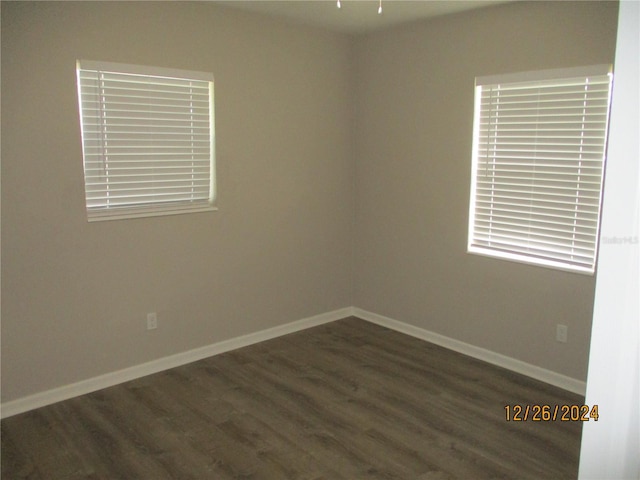 unfurnished room with dark hardwood / wood-style floors