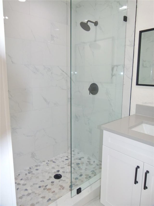 bathroom featuring vanity and a tile shower