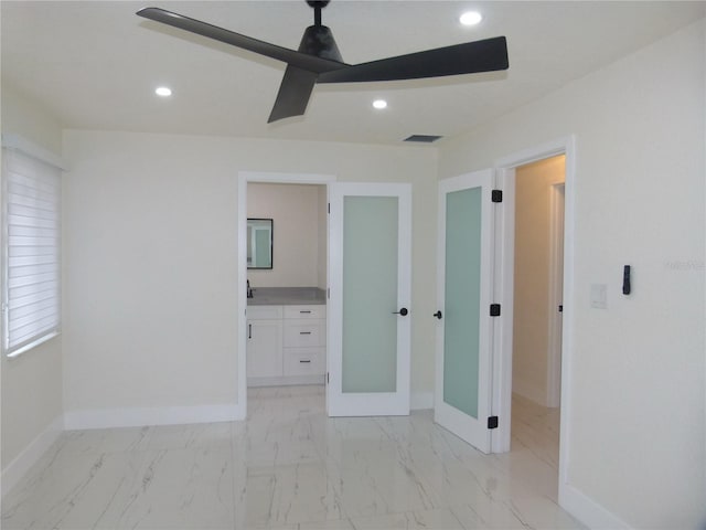 unfurnished bedroom with ensuite bathroom and ceiling fan