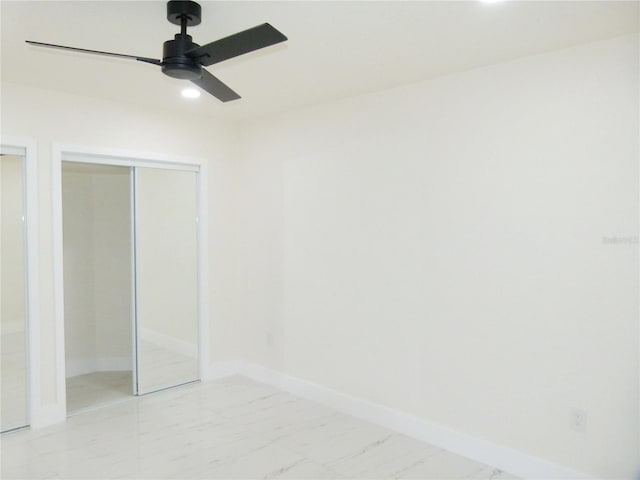 unfurnished bedroom featuring ceiling fan and a closet