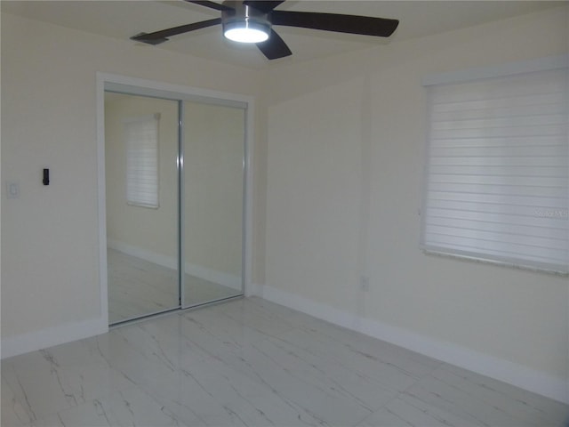 unfurnished bedroom with a closet and ceiling fan