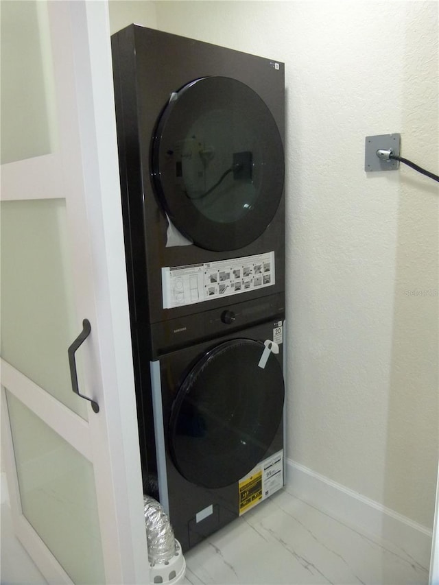 laundry area with stacked washing maching and dryer