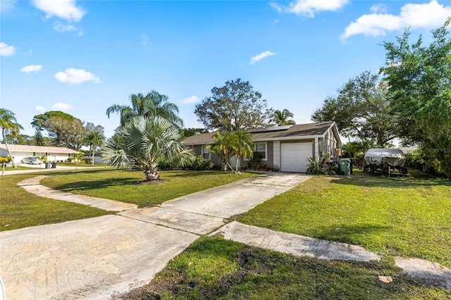 view of front of home featuring a garage and a front lawn