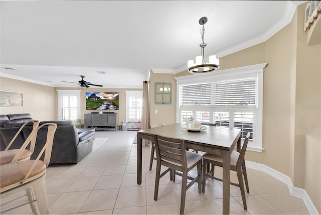 dining area featuring ceiling fan with notable chandelier, light tile patterned floors, and crown molding