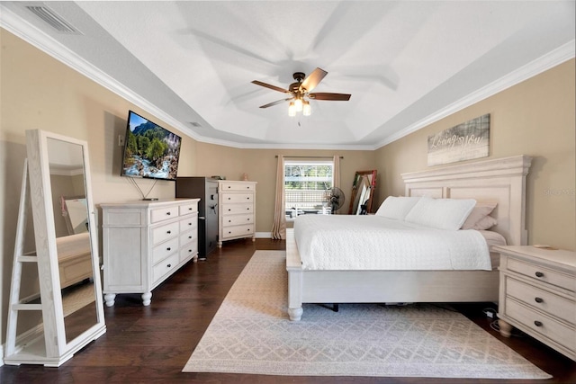 bedroom featuring dark hardwood / wood-style floors, a raised ceiling, ceiling fan, and crown molding