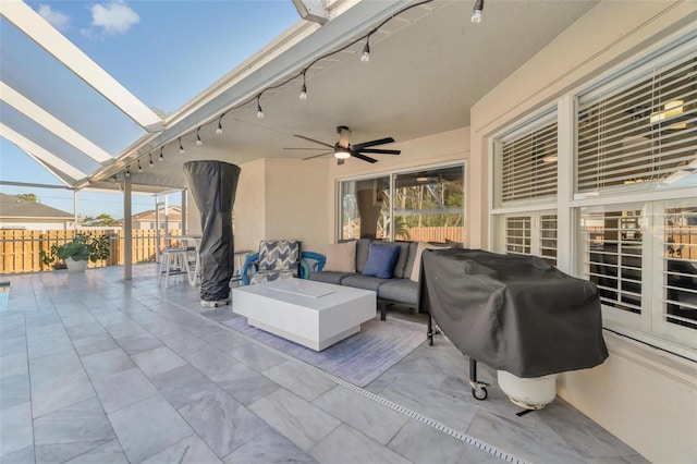 view of patio / terrace with an outdoor hangout area, area for grilling, ceiling fan, and a lanai