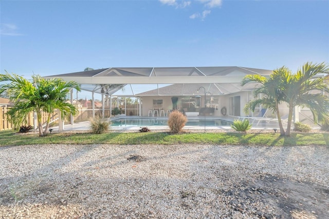 back of property featuring a lanai and a patio