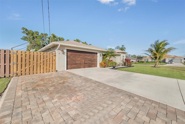 ranch-style home with a garage and a front yard