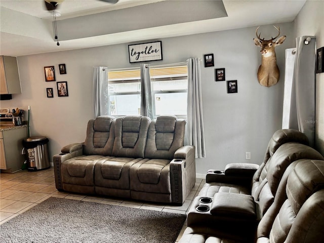 tiled living room featuring a raised ceiling