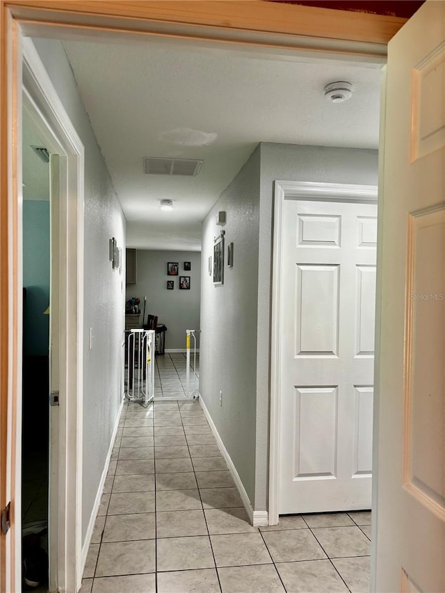 hall with light tile patterned flooring