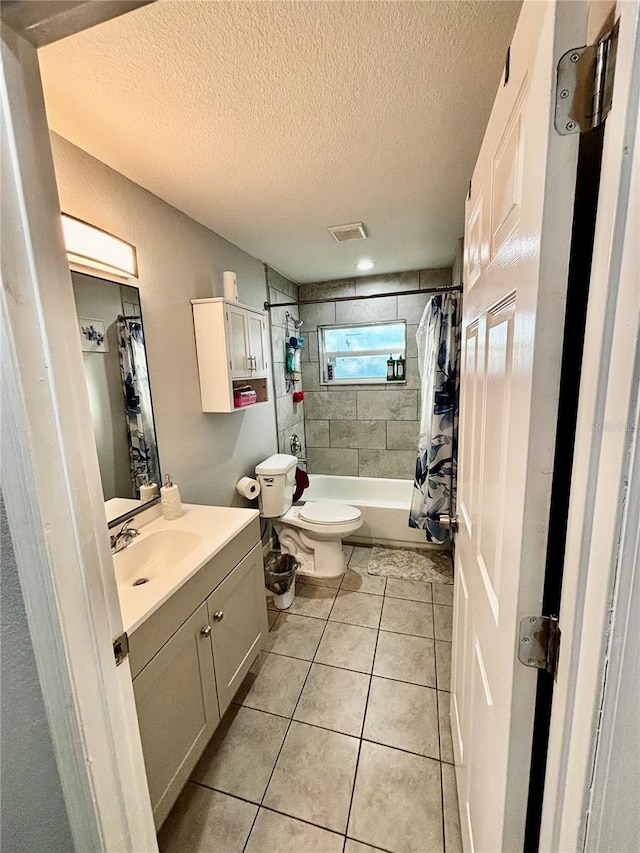 full bathroom featuring vanity, tile patterned floors, toilet, shower / bathtub combination with curtain, and a textured ceiling