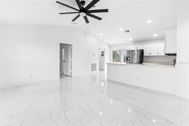 unfurnished living room featuring ceiling fan and lofted ceiling