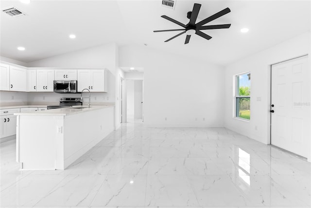 kitchen with white cabinetry, ceiling fan, stainless steel appliances, and vaulted ceiling