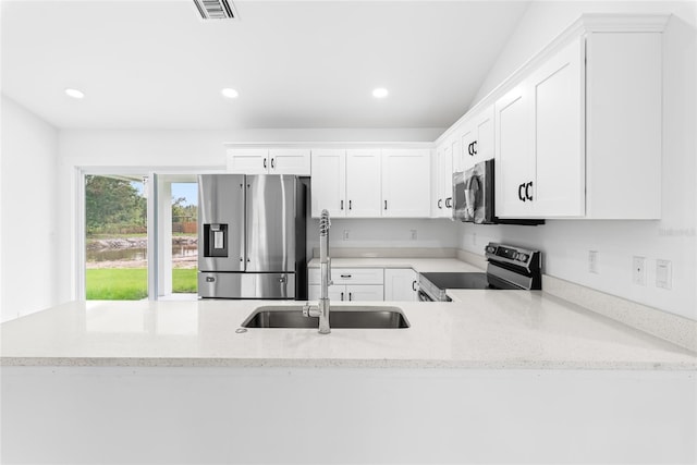 kitchen featuring white cabinets, sink, kitchen peninsula, and stainless steel appliances