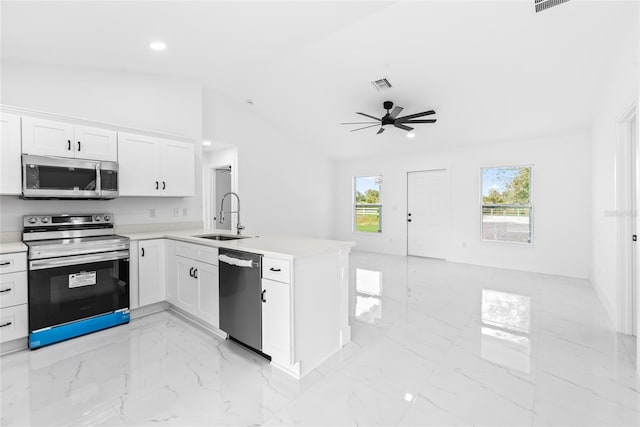 kitchen with white cabinets, stainless steel appliances, kitchen peninsula, and sink