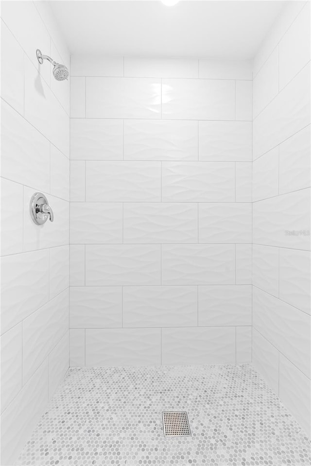 bathroom with tiled shower