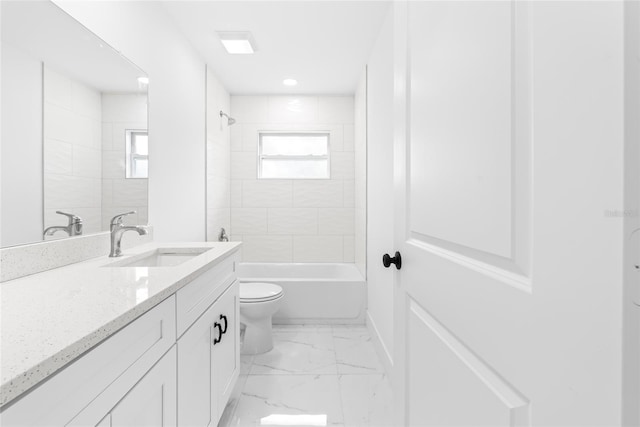 full bathroom with vanity, toilet, tiled shower / bath, and a wealth of natural light