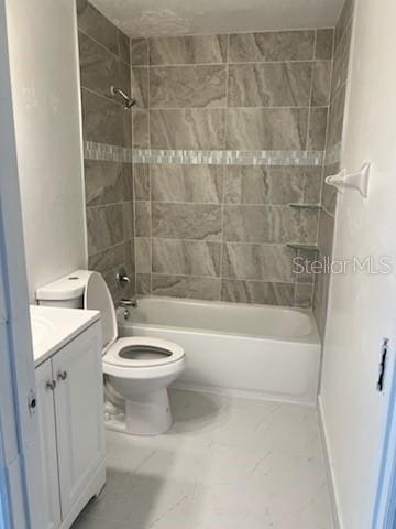 full bathroom with toilet, tiled shower / bath, and vanity