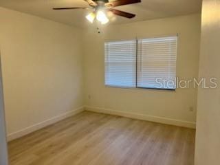 spare room with ceiling fan and light wood-type flooring