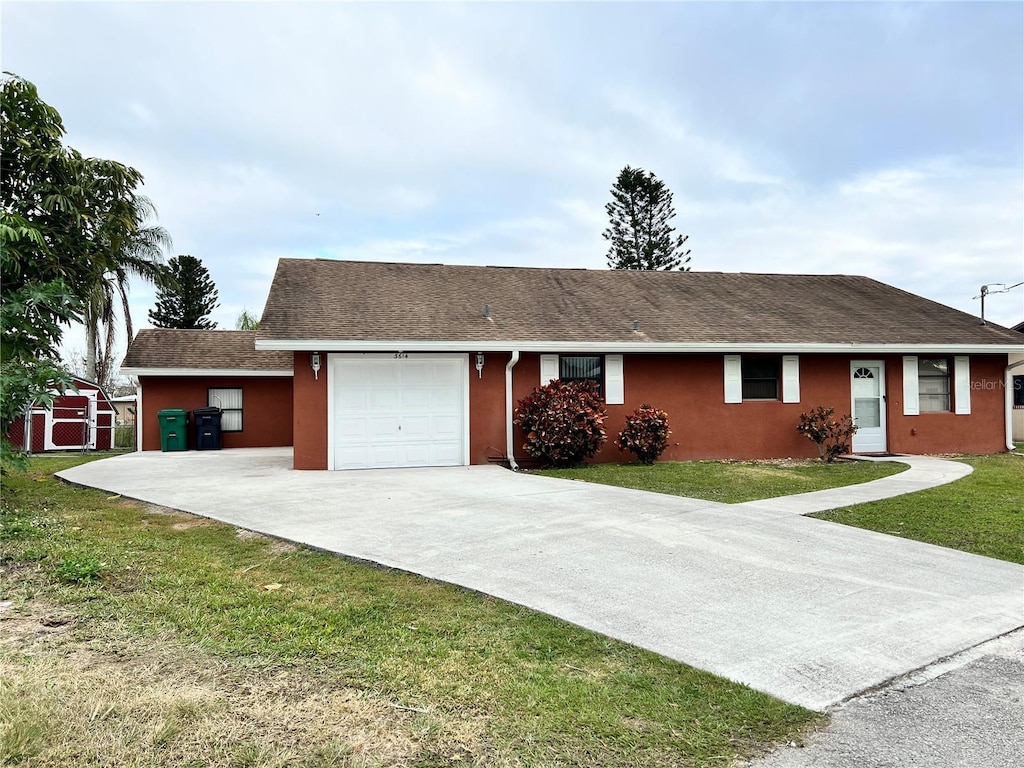 ranch-style home with a garage and a front yard