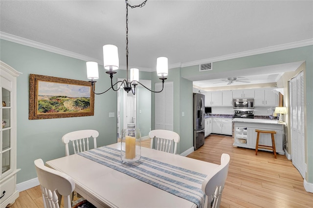 dining space featuring ceiling fan with notable chandelier, ornamental molding, and light wood-type flooring